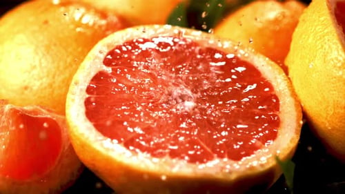 Refreshing Grapefruits Under Water Splash Close Up