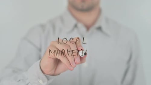 Writing Local Marketing with Marker on Glass