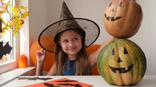 Smiling Girl with Halloween Pumpkins in Home Setting