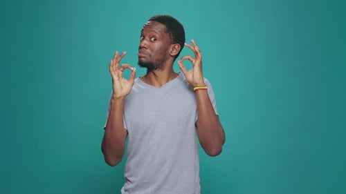 Man Smiling and Gesturing OK with Both Hands