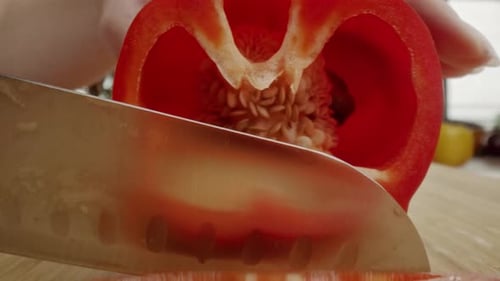 Slicing Fresh Red Bell Pepper with Sharp Knife