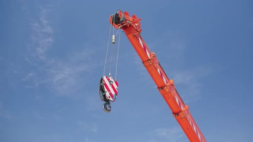 Orange Crane Against Blue Sky Slowly Moving
