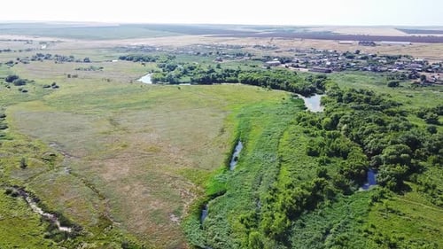 Aerial Aerial View. Summer Rural Landscape: River, Trees Near and Fields on the Horizon