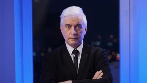 Man in Suit at Night with Arms Crossed