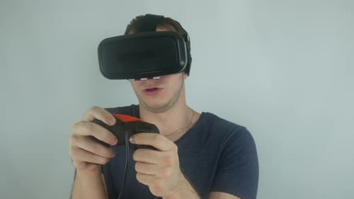 Man Experiences Virtual Reality Gaming With Headset