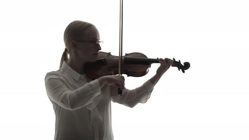 Woman Musician in a Shirt Plays the Violin with a Bow in Studio on White Background