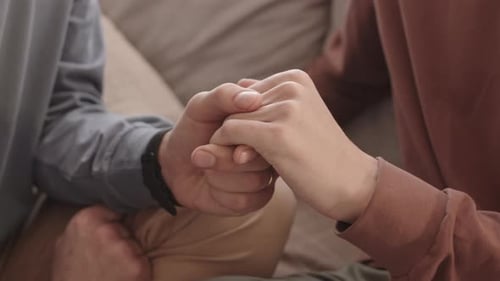 Two Unrecognizable Men Holding Hands of Each Other