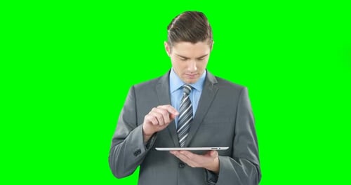 Man in Suit Using Tablet on Green Screen