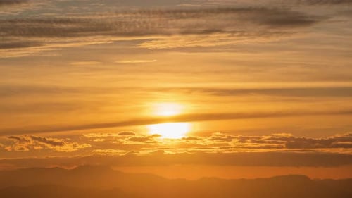 Golden Sunset Time Lapse Over Distant Mountains