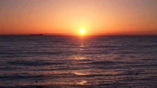 Dawn Above the Sea On the Horizon are Visible Cargo Ships
