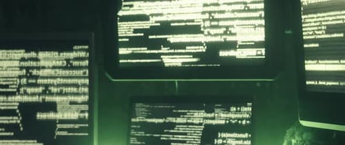 Eerie Monitors Displaying Futuristic Code in Dark Room