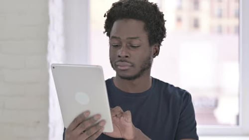 African Man Using Tablet in Office