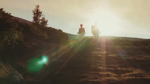Couple Hiking a Mountain at Sunrise