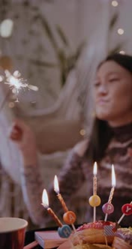 Young Woman Celebrates Birthday with Donuts and Sparklers