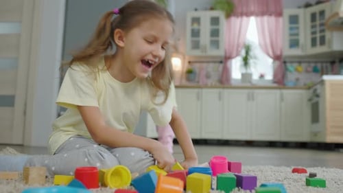 Happy Child Playing with Colorful Blocks at Home