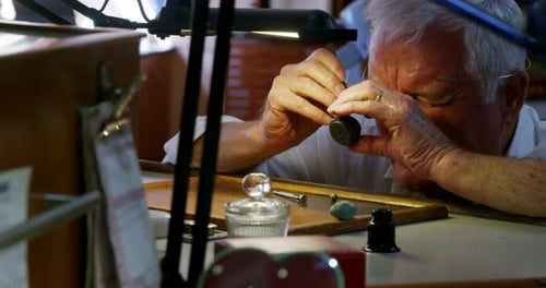 Horologist repairing a watch