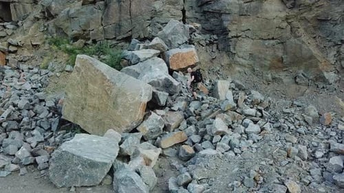 Man Walking along Giant Rocky Mountain Wall. Travel concept. Aerial view