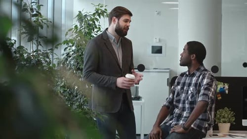Businessmen Chatting Casually in a Modern Office