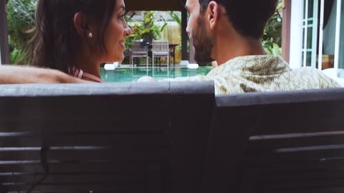 Couple Embraces by Tropical Villa Swimming Pool