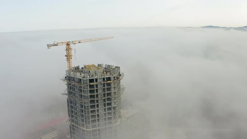 A Building Under Construction Made of Monolithic Concrete Shrouded in Fog