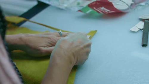 Sewing Machine in a Leather Workshop in Action with Hands Working on a Leather Details for Shoes