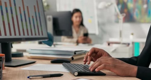 Closeup of a Black Keyboard From a Computer Standing on a Wooden Desk a Darkskinned Man with Young