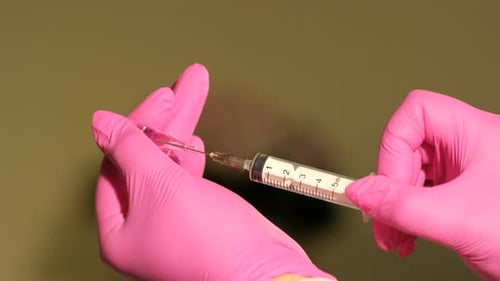 Hands Fill Hypodermic Syringe with Medical Liquid