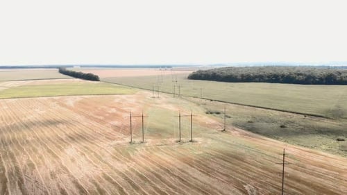 Rolling Fields and Power Lines Aerial Shot