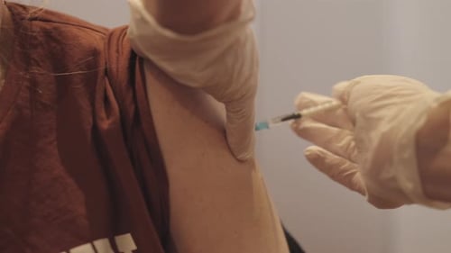 Medical Professional Giving Vaccine Injection to Patient