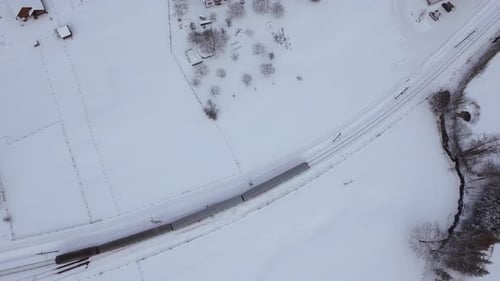 Aerial view of train rolling on winter time