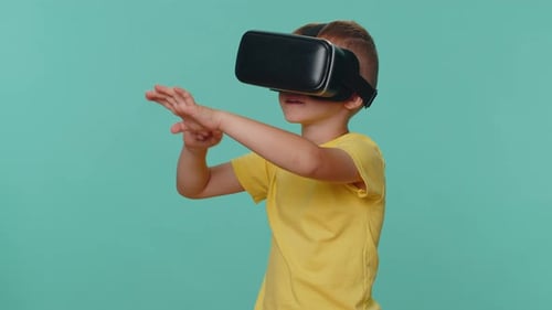 Boy Wearing VR Headset Interacting with Virtual Reality