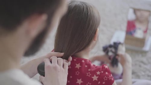 Father Brushes Child's Hair at Home