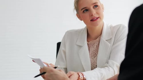 Woman Discussing Business with Colleague in Office Setting