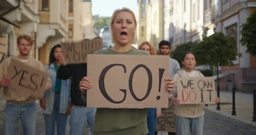 Group Protesting with Signs in Urban Street