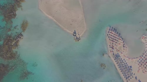 Aerial view of a paradise beach with umbrellas. Idyllic vacation concept