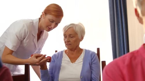 Senior Woman Exercising with Caregiver Assistance