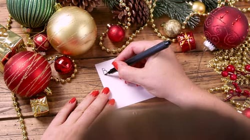 Hands Write Message with Christmas Holiday Decorations