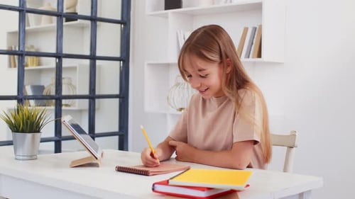 Young Girl Studying at Home with Tablet