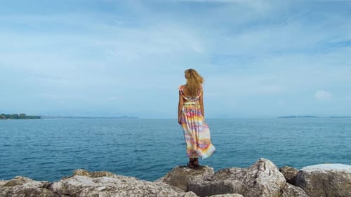 Girl in a Beautiful Dress Is Standing on the Coast