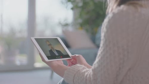Woman having video call with man