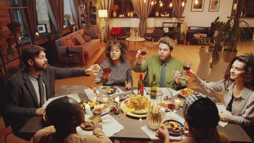 Friends Celebrate Together at Dinner Party with Toast