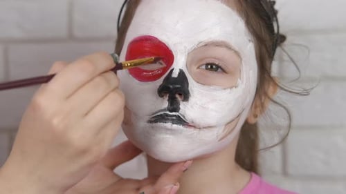 Beautiful little girl on Halloween make face art.