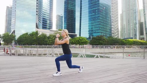 Blonde Woman Doing Lunges in the City