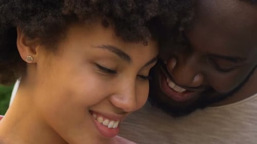 Affectionate Young Couple Smiling Together in Close Up
