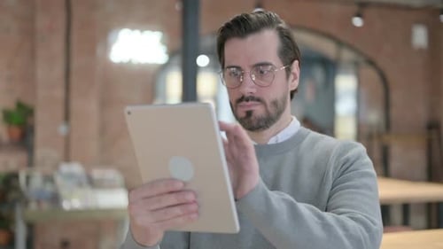 Man Using Tablet in Modern Office Environment