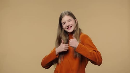 Teen Girl Smiles and Gives Two Thumbs Up