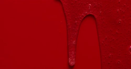 Bright Red Fluid Dripping Slowly Abstract Background