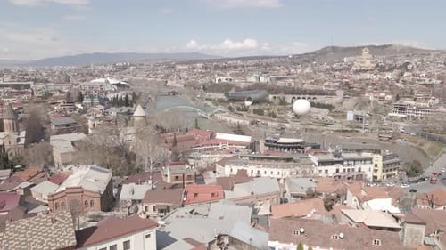 Aerial view of Tbilisi city central park and Bridge of Peace. Beautiful cityscape of old Tbilisi
