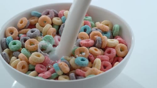 Pouring Milk on Cereal Loops in Bowl