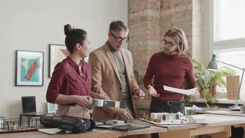 Architecture Team Collaborating on Building Design in Office